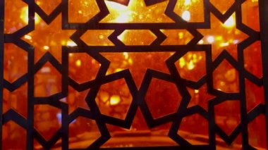Close-up shot of beautiful Turkey Turkiey illuminate orange glass lamp with isalamic crafted pattern metal details
