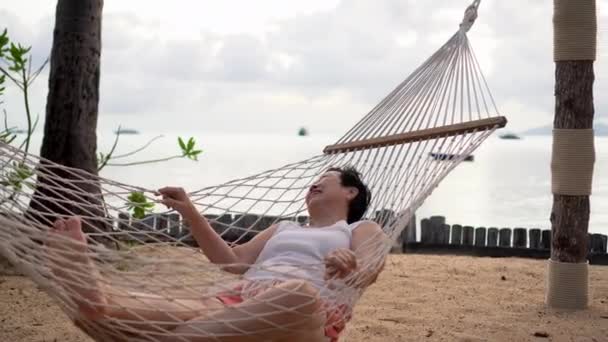 Azjatycka Seniorka Leżąca Hamaku Rajskiej Plaży Myśląca Życiu Przejściu Emeryturę — Wideo stockowe