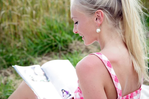 Mujer joven leyendo una revista —  Fotos de Stock