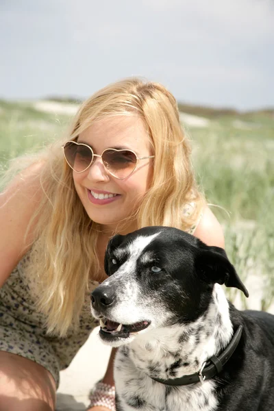Young blonde woman with dog — Stock Photo, Image