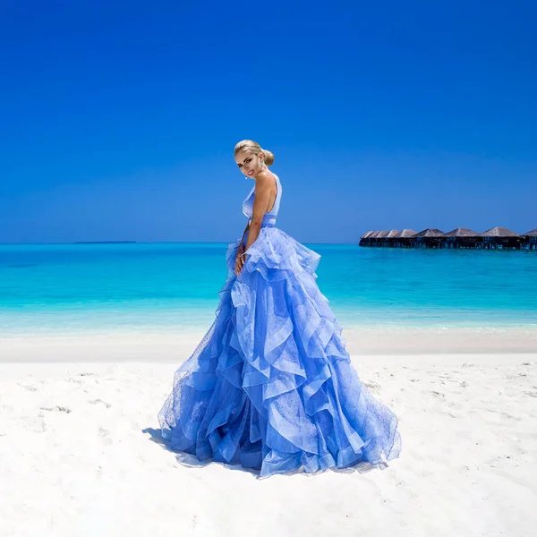 Luxury fashion. Elegant fashion model. Stylish female model in elegant long gown dress on the Maldives beach. Elegance. Bride on Maldives. Bridal fashion. Classy woman in amazing blue dress. Couture.