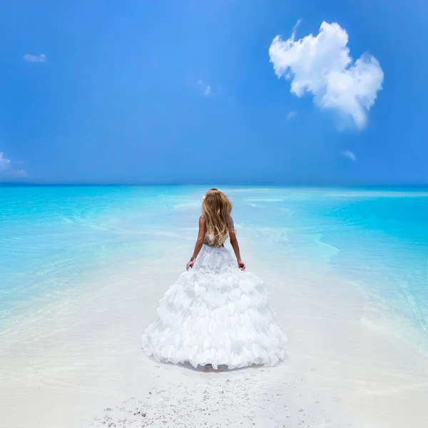 Bride on the beach. Stylish female model in elegant long gown dress on the Maldives beach. Elegance. Bride on Maldives. Bridal fashion. Classy woman in amazing ruffle white dress. Luxury travel