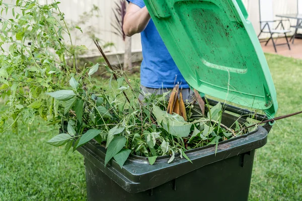 装满花园垃圾的绿色垃圾箱 春天来了为创造更好的环境而进行垃圾回收利用 — 图库照片
