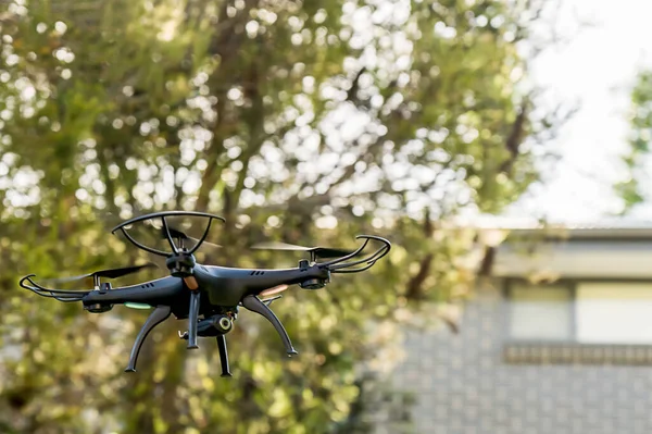 Drone camera quad copter flying near residential buildings. Drone photography and videography. Drone flight.