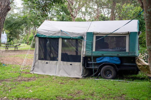 Canvas camper trailer on a campsite at the holiday caravan park. vacation travel concept