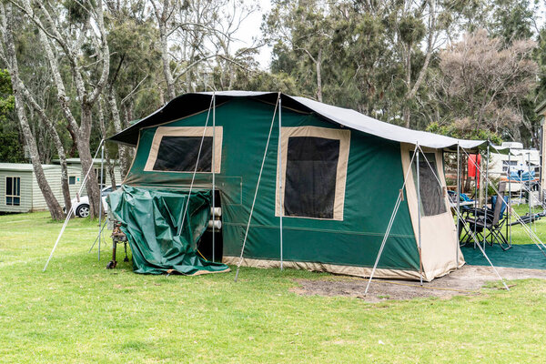 Canvas camper trailer on a campsite at the holiday caravan park. vacation travel concept