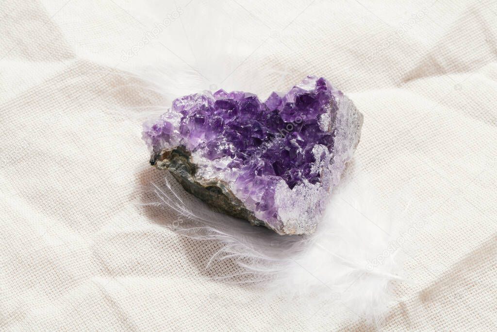 druse raw purple amethyst crystal on piece of stone on grey linen, magic rock for ritual, witchcraft, spiritual practice, meditation