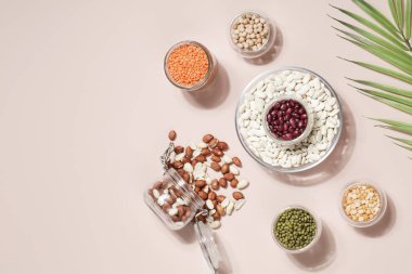Vegan protein kaynağı. Fasulye, bezelye, nohut, mercimek, fasulye, bej arka planda fıstık. Sağlıklı vejetaryen yemekleri. Boşluğu kopyala