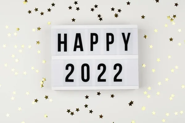 Lightbox con palabras felices 2022 y confeti navideño sobre fondo blanco. arriba ver celebración de año nuevo. — Foto de Stock