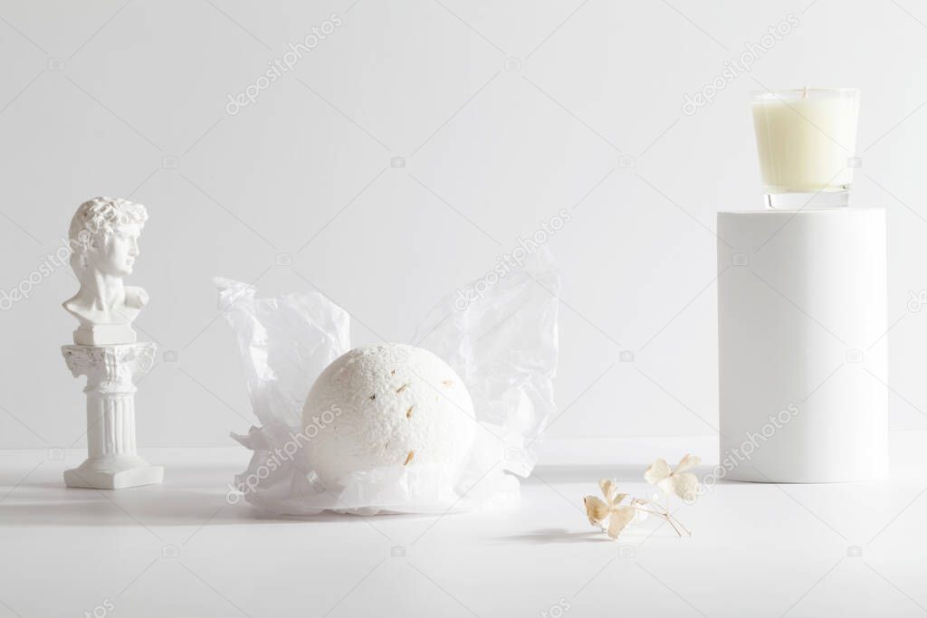 bath bomb and candle on podium on white background. Still life for wall decoration in resort spa or salon. Spa, relax, wellness concept. 