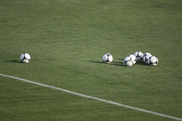 Soccer balls in grass stadium — Stock Photo, Image