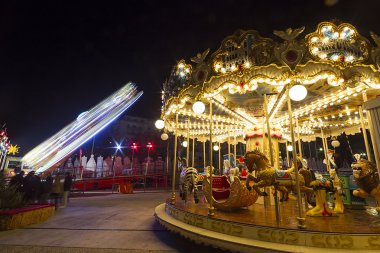 Luna park carousel in a public outdoor area clipart