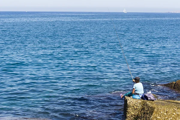 Fishing - woman fishing on the beach — Stock Photo, Image