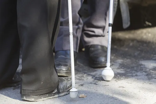 Close up in blind man's feet with stick — Stock Photo, Image