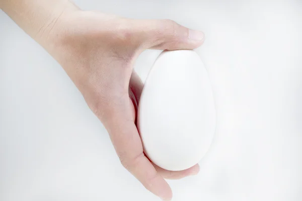 Hand holding big goose egg, isolated on white background — Stock Photo, Image