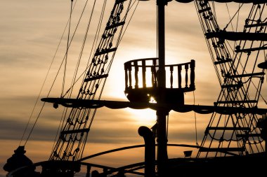 Silhouette of sails of an antique ship, masts and bowsprit of a  clipart