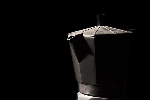 Close up of a typical Italian coffee maker in the shadows in bla — Stock Photo, Image