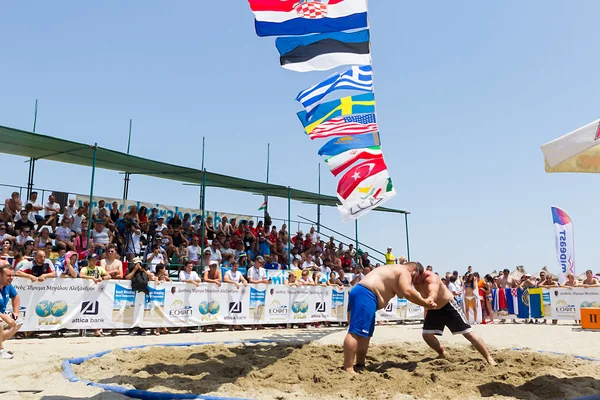 Twee mannelijke atleten worstelen op zand tijdens de eerste champio van de wereld — Stockfoto