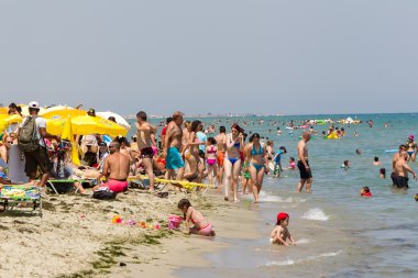 Very Crowded Beach Full Of People At Katerini Beach, in Greece.  clipart