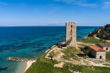 Aerial view of  byzantine tower and beach of village Nea Fokea in peninsula Kassandra Halkidiki Greece