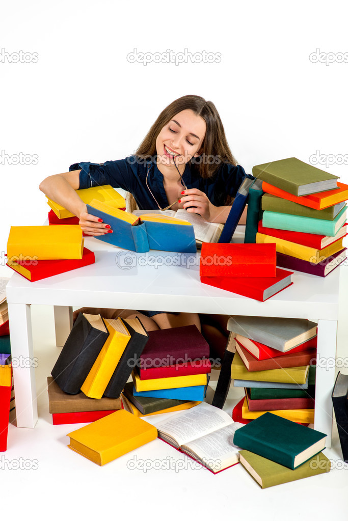 Young and smart girl sitting and reading surrounded by colorful 