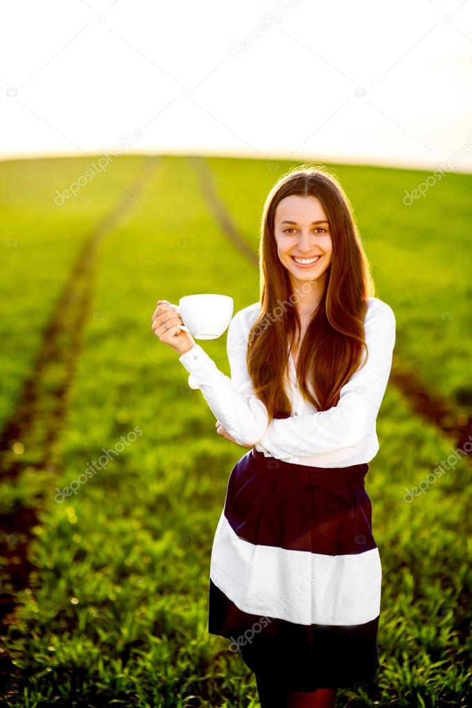 Beautiful happy young woman or girl smiling and drinking coffee 