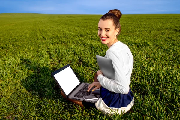 Smiling business woman with laptop, tablet and phone sitting on — Stock Photo, Image