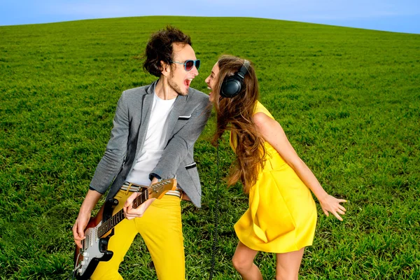 Jeune couple jouant à la guitare et appréciant la musique, ils doivent — Photo