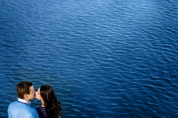 Young couple in love relaxing on terrace near water — Stock Photo, Image