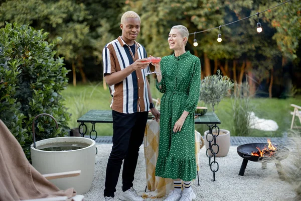 Multiracial couple having a dinner at their backyard — Stock Photo, Image