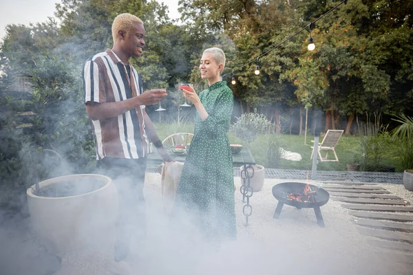 Multiracial couple having a dinner at their backyard — Stock Photo, Image