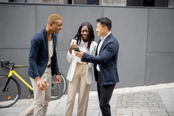 Group of business people watching on smartphone — Stock Photo, Image