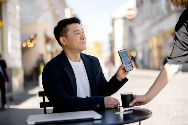 Homem mostrar telefone com aplicativo Vacinação no café — Fotografia de Stock