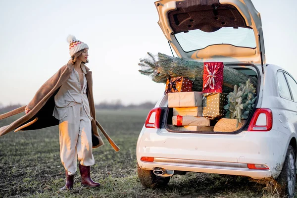 Vrouw en auto vol met Nieuwjaar geschenkdozen — Stockfoto