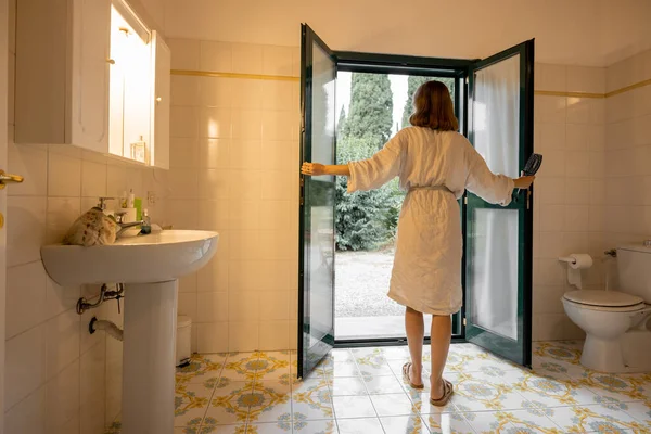 Girl going in bathroom of hotel room at morning — Stock Photo, Image