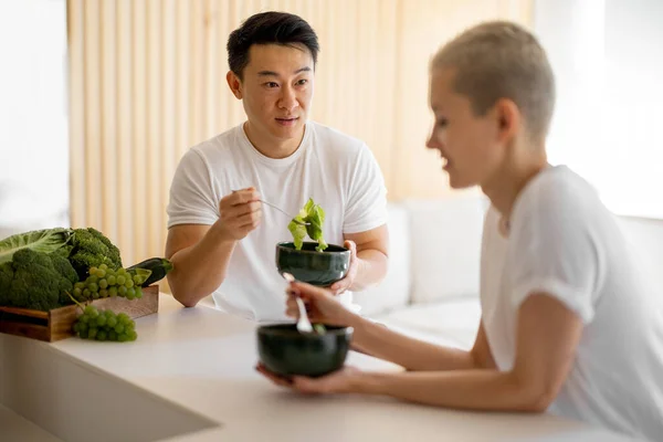 家庭で新鮮な野菜からサラダを食べるカップル — ストック写真