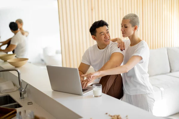 Multiracial couple with laptop at modern apartment — Stok fotoğraf
