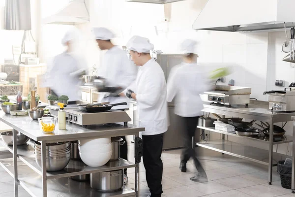 Chef cooks working in professional kitchen — Stock Photo, Image