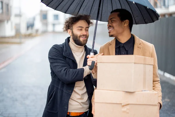 Homosexuella par går tillsammans med paket utomhus — Stockfoto