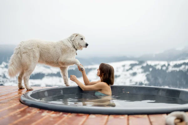 Femme se reposer avec un chien à la montagne — Photo