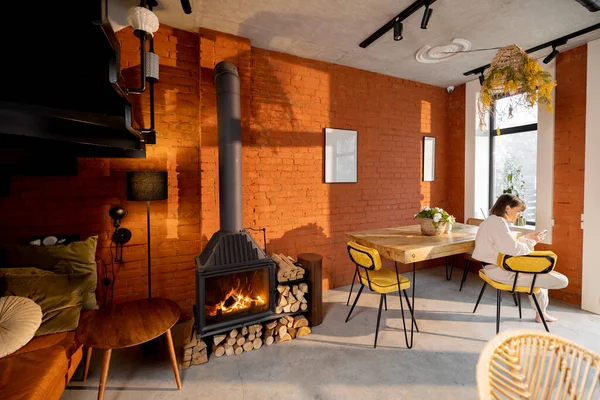 Interior of living room with fireplace and dining place in loft style — Stock Photo, Image