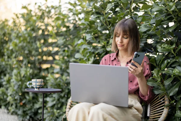 Woman works on laptop computer at garden — Stock Photo, Image