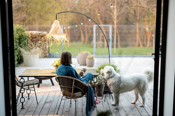 Woman with dog at home terrace in the garden — Photo