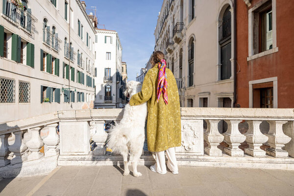 Woman with dog traveling in Venice, Italy