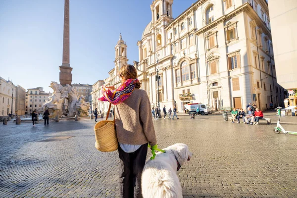 Woman walks with italian shepherd dog on Navona square in Rome