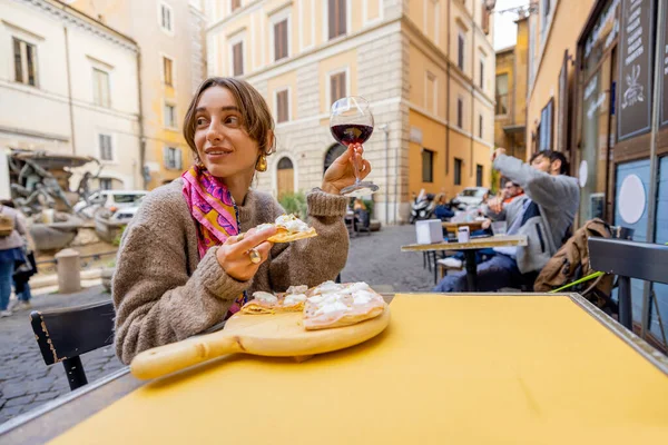 Жінка їсть піцу в ресторані на вулиці. — стокове фото
