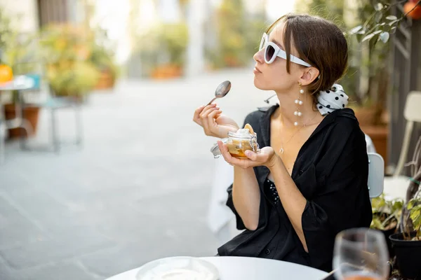 Kvinna äter tiramisu dessert på restaurangen utomhus — Stockfoto