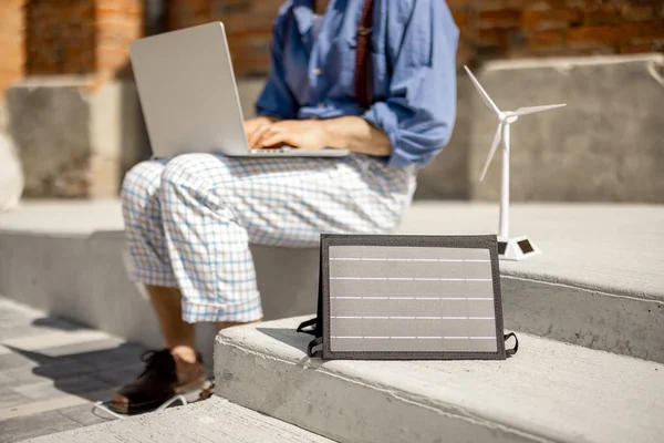 Stylish Man Works Laptop Charge Portable Solar Panel While Sitting — ストック写真