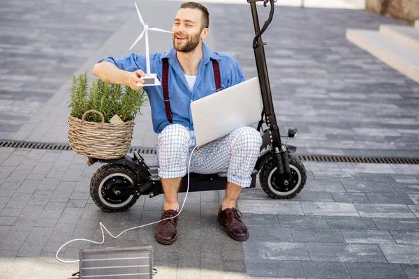 Man Blows Toy Wind Generator While Sitting Laptop Green Plant — Stock Fotó