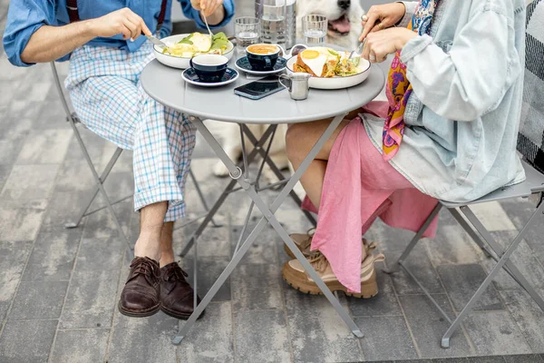 男と女のおいしい朝食は カフェテラスに座っている 足や食事に焦点を当てた作物のビュー — ストック写真